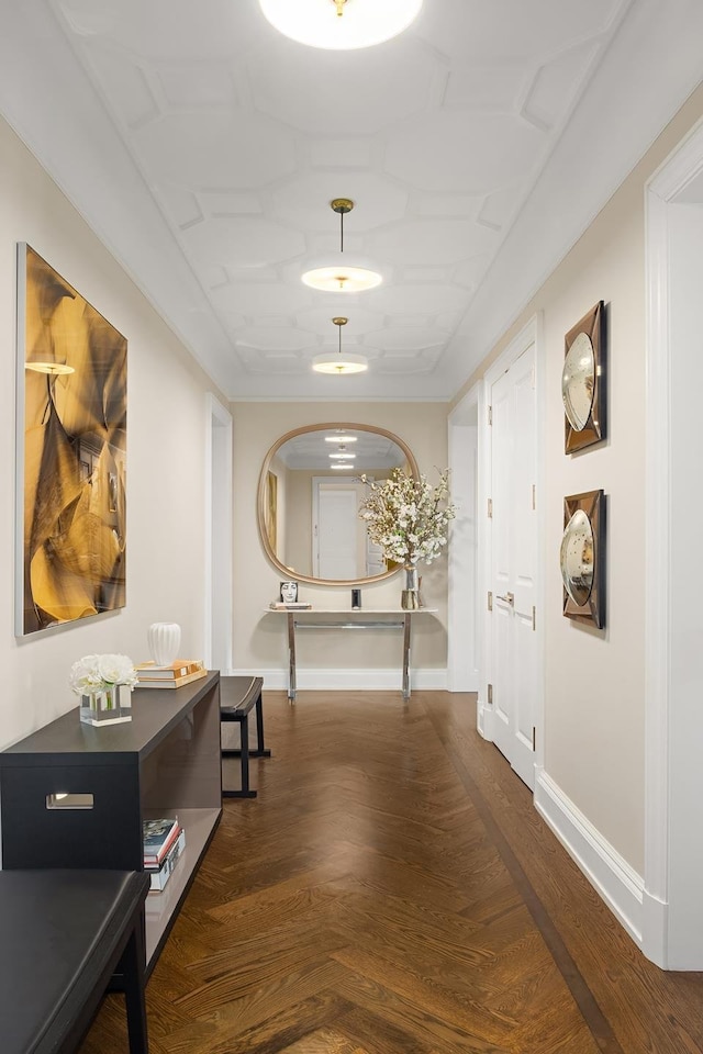 corridor featuring arched walkways, wood finished floors, and baseboards