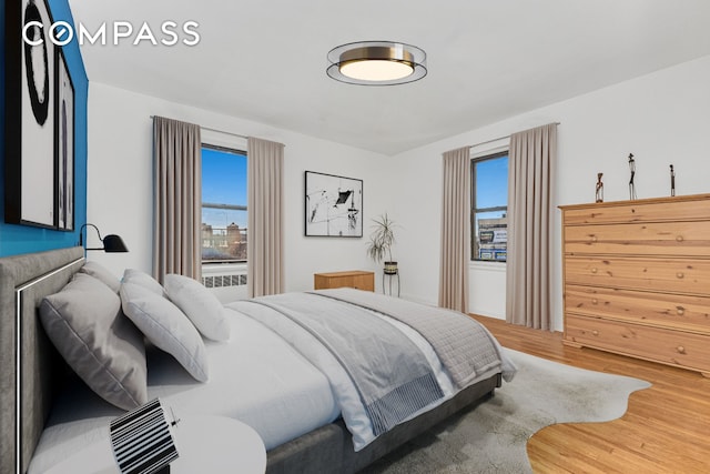 98 Park Ter E Unit 3A, New York City, NY 10034 - bedroom featuring multiple windows and wood finished floors