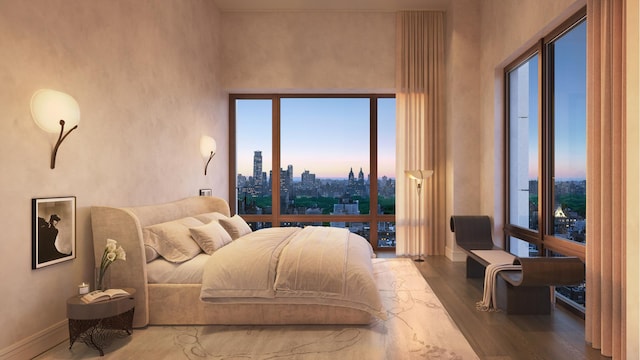 bedroom with a city view, baseboards, and wood finished floors