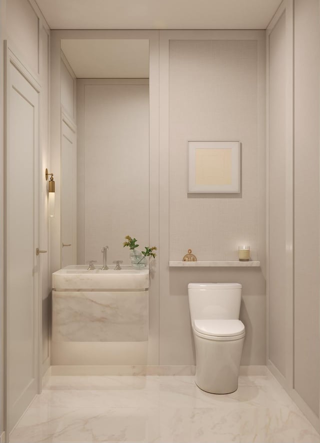 bathroom with marble finish floor and toilet