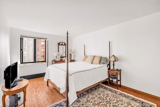 bedroom featuring light wood-type flooring and baseboards