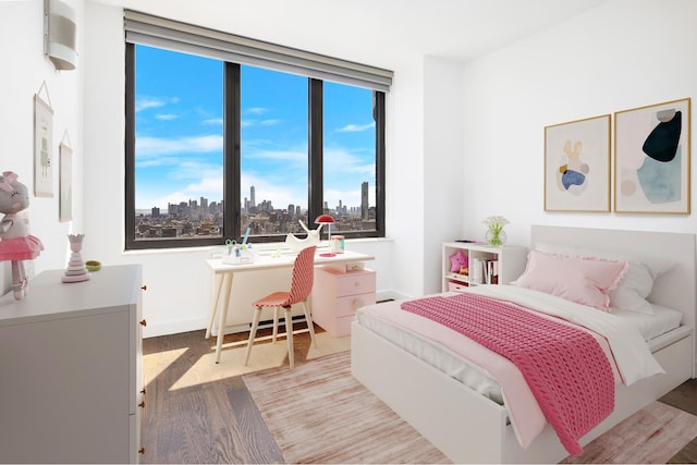 bedroom featuring light wood-type flooring, a view of city, and baseboards