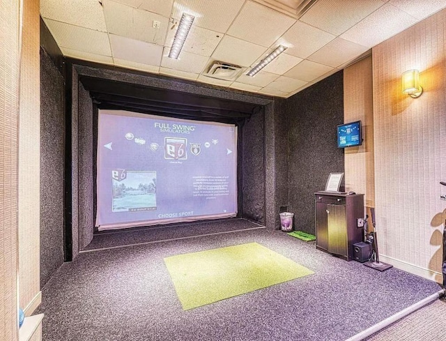 game room with a drop ceiling, golf simulator, and carpet flooring