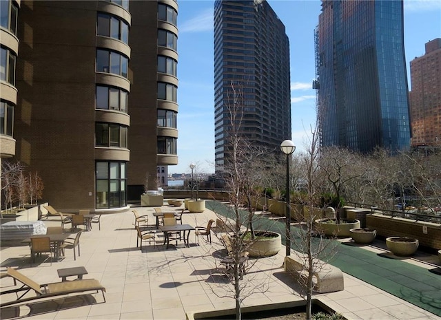 view of home's community featuring a view of city and a patio area