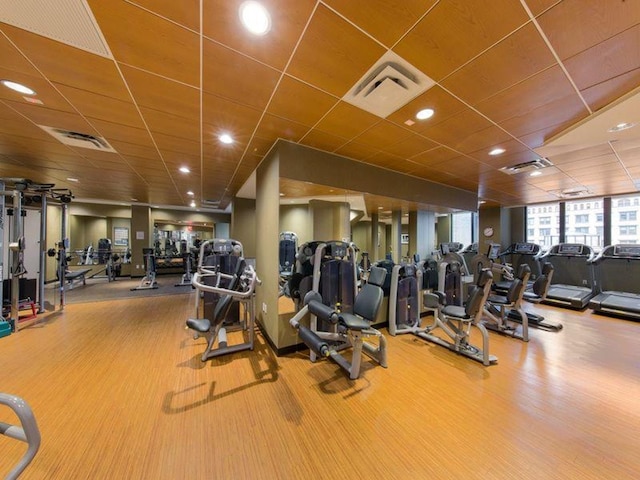 exercise room featuring a paneled ceiling and visible vents