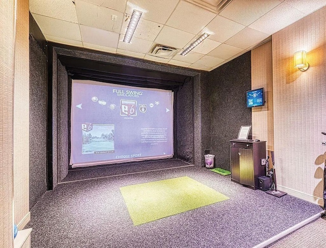 carpeted cinema featuring golf simulator, visible vents, baseboards, and wallpapered walls