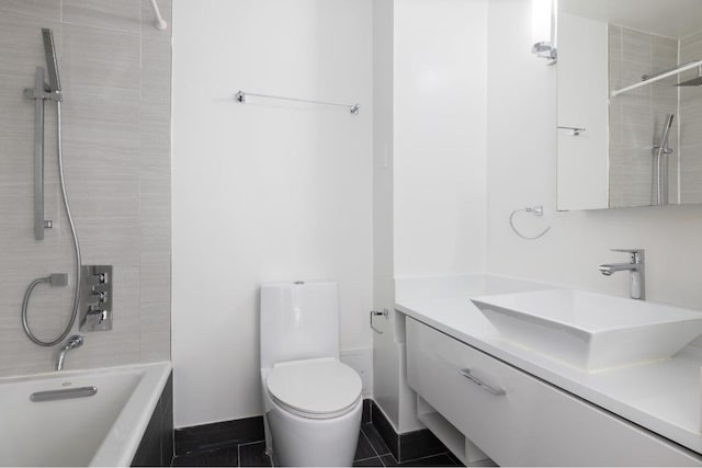 full bathroom with tiled shower / bath combo, tile patterned floors, vanity, and toilet