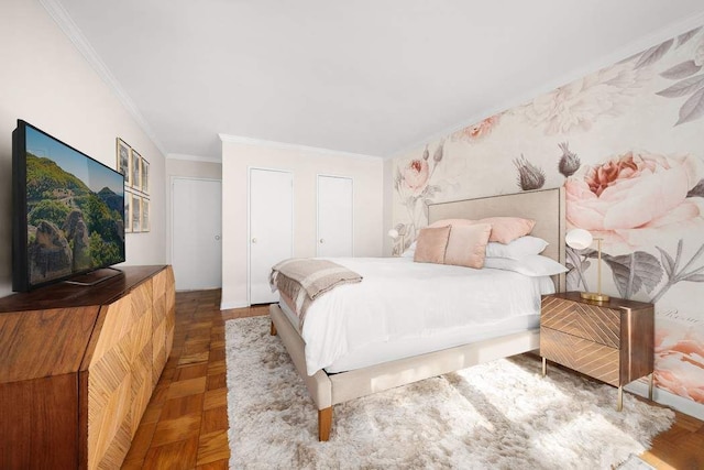 bedroom with multiple closets and ornamental molding