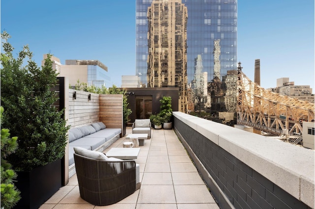 balcony with an outdoor living space, a city view, and a patio area