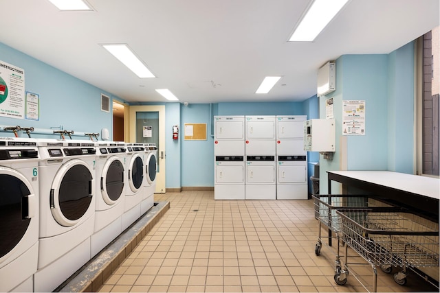 community laundry room featuring stacked washer / dryer, light tile patterned floors, separate washer and dryer, and visible vents