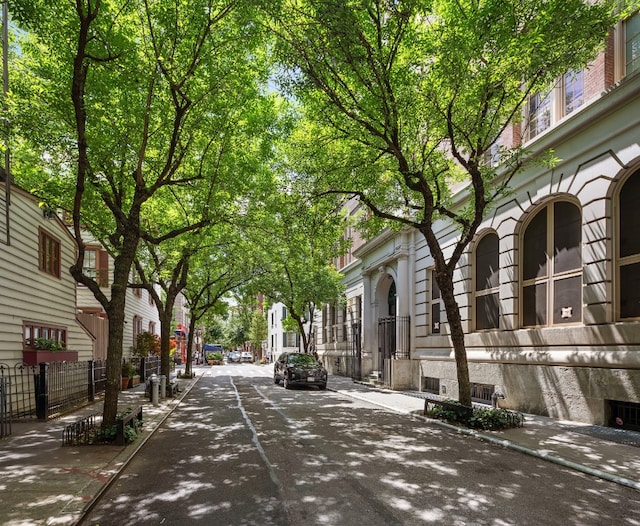 view of road with sidewalks and curbs