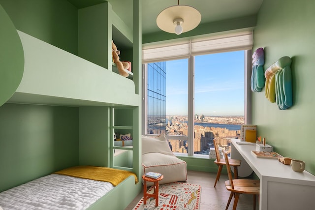 252 S St Unit 76E, New York City, NY 10002 - bedroom featuring multiple windows and wood finished floors