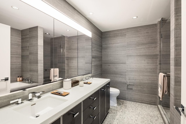 252 S St Unit 76E, New York City, NY 10002 - full bathroom featuring tile walls, toilet, recessed lighting, double vanity, and tiled shower