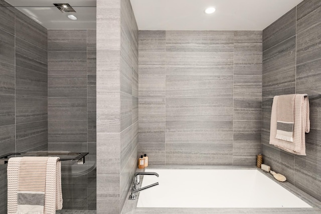 252 S St Unit 76E, New York City, NY 10002 - full bath featuring a garden tub, tile walls, a stall shower, and recessed lighting