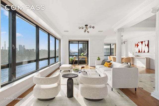 sunroom / solarium featuring a water view and a city view