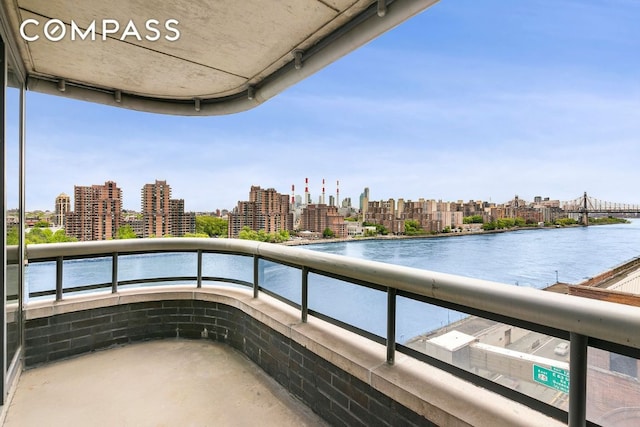 balcony featuring a city view and a water view