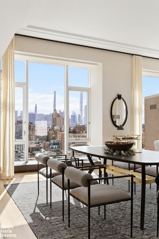 dining area with a wealth of natural light and hardwood / wood-style floors