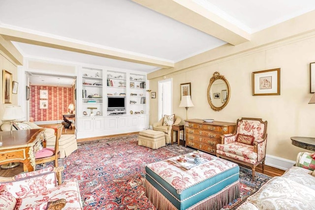 living room with crown molding, beam ceiling, wood-type flooring, and built in shelves