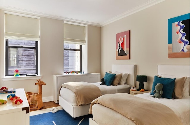 bedroom with hardwood / wood-style flooring and crown molding