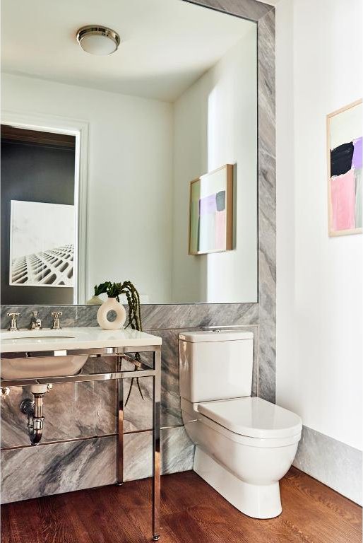 bathroom featuring hardwood / wood-style flooring, toilet, and sink