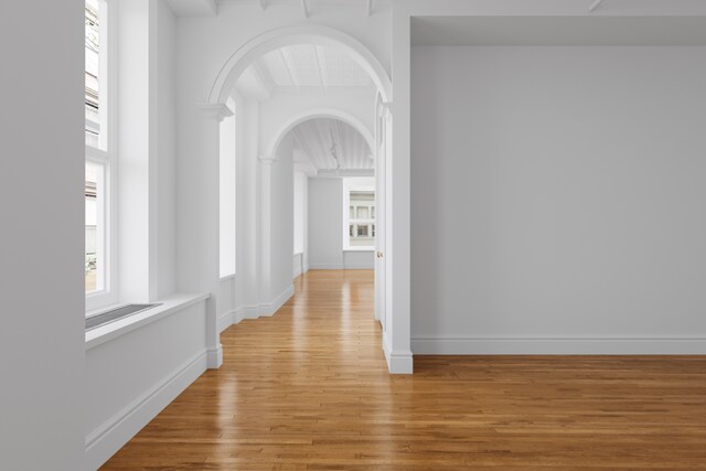 empty room with ceiling fan and light wood-type flooring