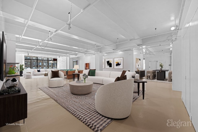 unfurnished room with coffered ceiling, beam ceiling, and concrete flooring