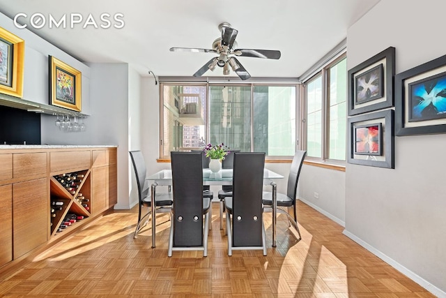 dining room featuring parquet floors and ceiling fan