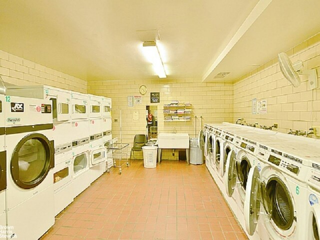 community laundry room with independent washer and dryer and stacked washing maching and dryer