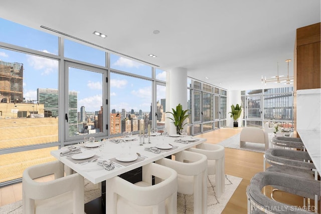 dining space with expansive windows and light hardwood / wood-style floors