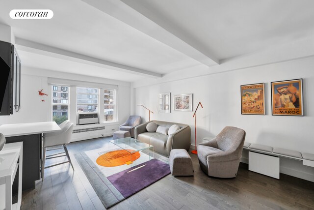 living room featuring beamed ceiling, dark hardwood / wood-style floors, and radiator heating unit