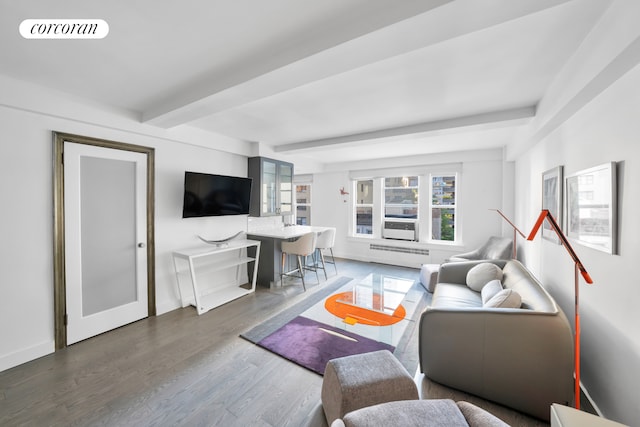 living room with baseboards, visible vents, beam ceiling, and wood finished floors