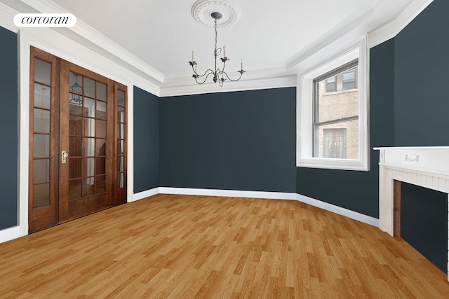 unfurnished dining area featuring a chandelier, a fireplace, visible vents, and crown molding