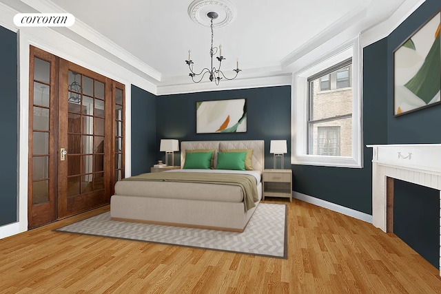144 E 36th St Unit 1C, New York City, NY 10016 - bedroom with a chandelier, wood finished floors, crown molding, baseboards, and a fireplace