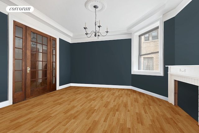 144 E 36th St Unit 1C, New York City, NY 10016 - unfurnished room featuring a chandelier, light wood finished floors, baseboards, crown molding, and a fireplace
