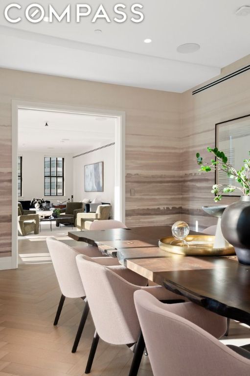 dining room with parquet flooring and wooden walls