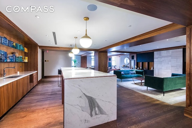 100 Barclay St Unit 21Ad, New York City, NY 10007 - kitchen with a sink, modern cabinets, wood finished floors, a kitchen island, and wooden walls