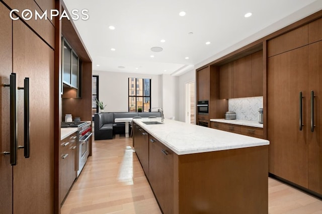 100 Barclay St Unit 21Ad, New York City, NY 10007 - kitchen featuring high quality appliances, a sink, light wood-style floors, modern cabinets, and recessed lighting