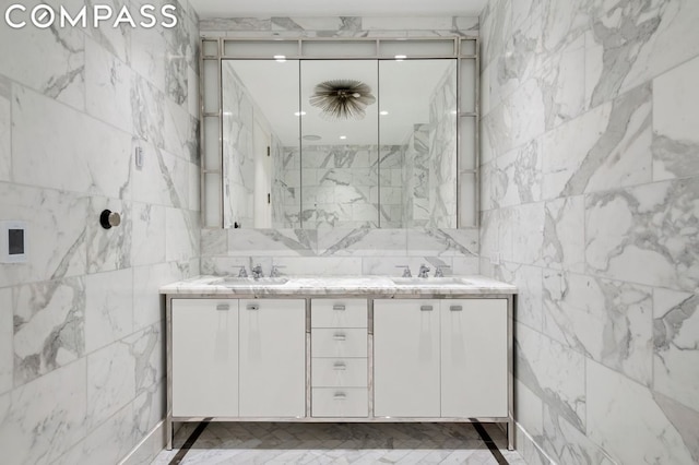 bathroom featuring vanity and tile walls