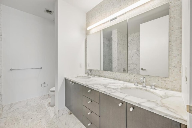 bathroom featuring toilet and vanity