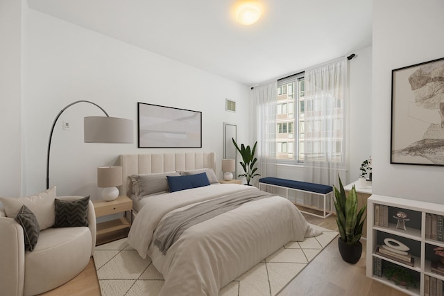 bedroom with visible vents and light wood finished floors