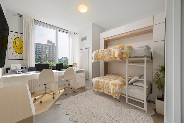 46-30 Center Blvd Unit 401, New York City, NY 11109 - bedroom with wood finished floors and a desk