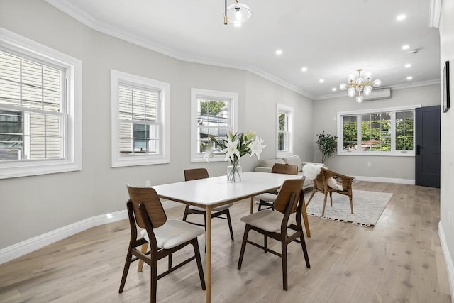 dining room featuring crown molding, plenty of natural light, a chandelier, and light hardwood / wood-style floors