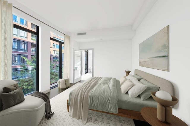 bedroom featuring visible vents and wood finished floors