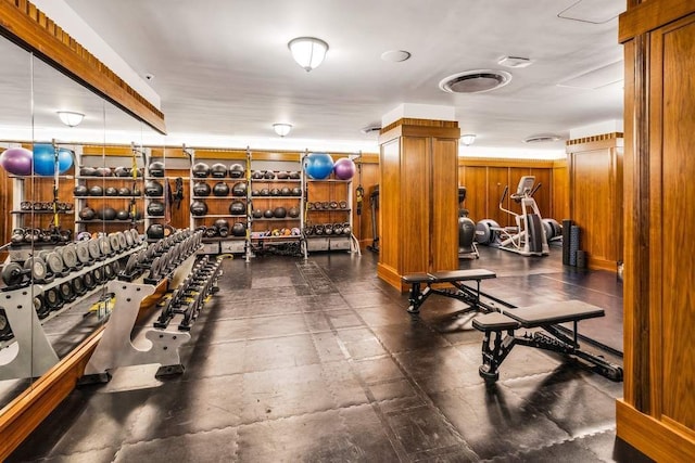 exercise room featuring wood walls