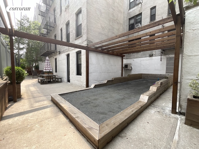 view of patio / terrace featuring a wall mounted air conditioner
