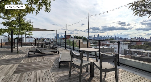wooden deck featuring a skyline view
