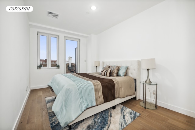 bedroom with hardwood / wood-style flooring