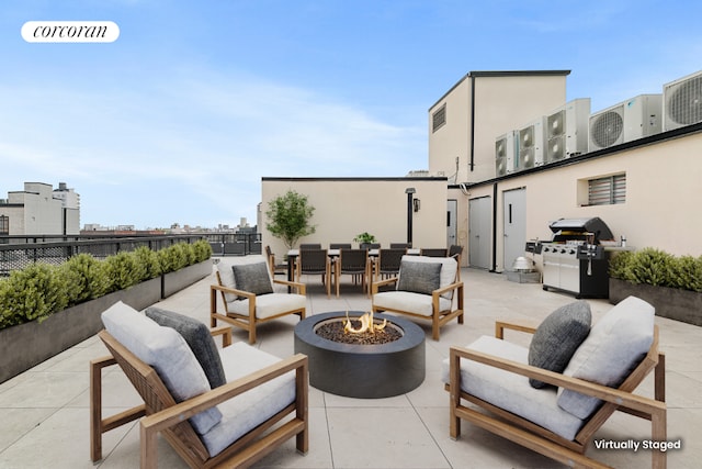 view of patio featuring an outdoor living space with a fire pit and a grill