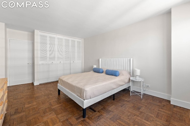 bedroom with dark parquet floors