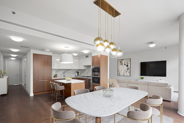 dining space with dark wood-type flooring, visible vents, and baseboards